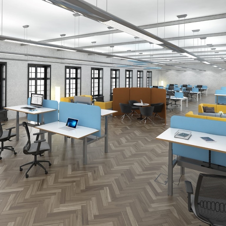 Modern open-plan office with sit-stand desks, ergonomic chairs and collaborative seating areas.