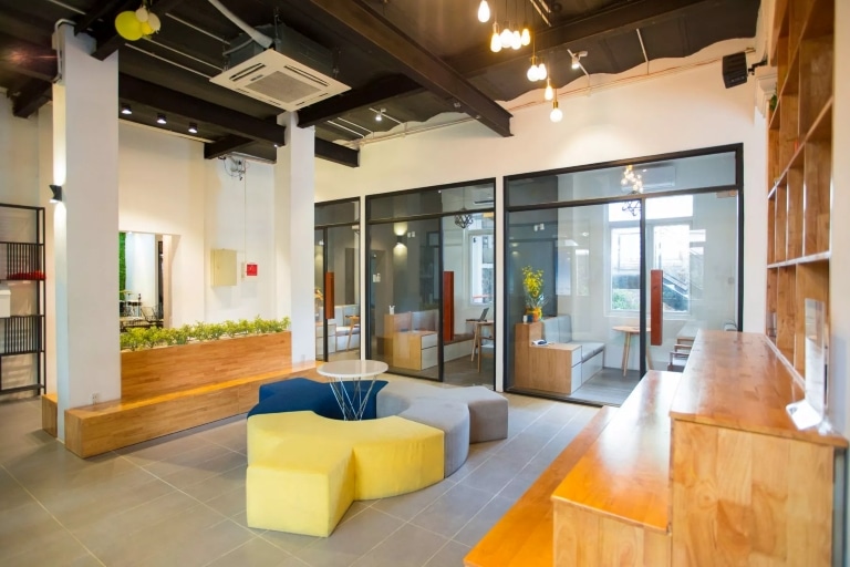 Spacious and well-lit office area with numerous seating arrangements for employees.