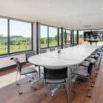 Large Commercial meeting room with an oval table.